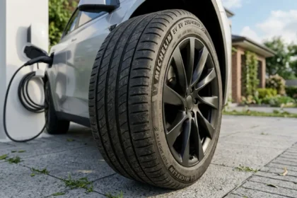 Modern electric SUV with premium EV tires parked beside a home charger